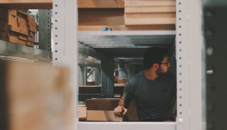 Man under iron shelves